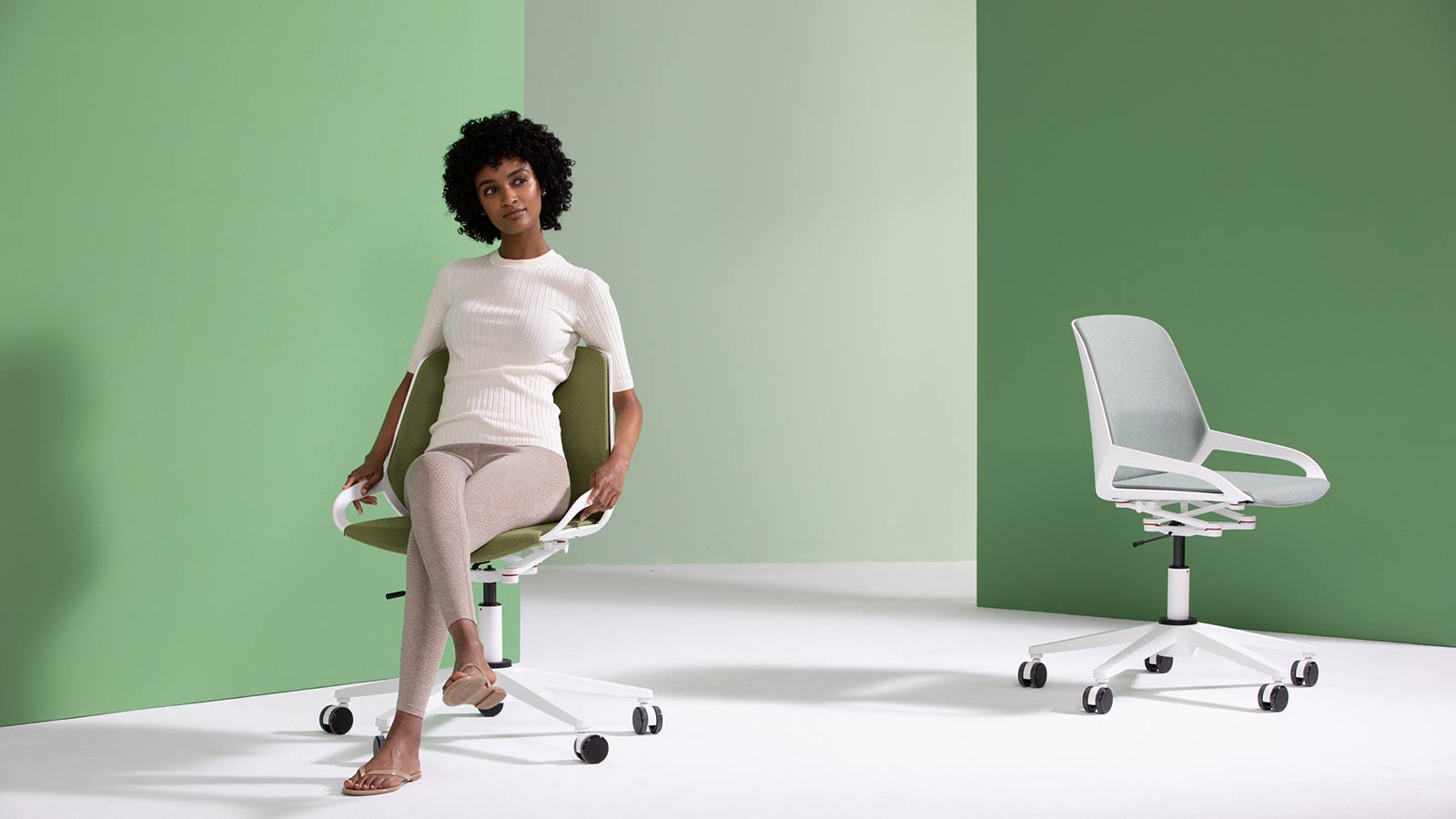 Bürostuhl Aeris Numo Task mit Frau auf Stuhl weißes Gestell Std. grün graue farbene Polster